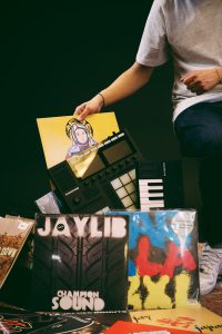A person sitting on top of a pile of records